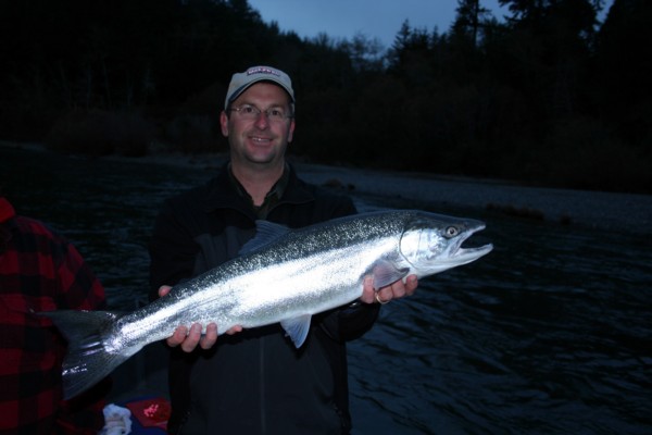 Brett Whitehead with a beautifal Chetco River steelhead he caught on his first cast while fishing with guide Andy Martin of Wild Rivers Fishing.