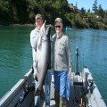 A 60-pound king held up by guide Andy Martin caught by Carl Johnson in the Chetco River estuary in 2009.